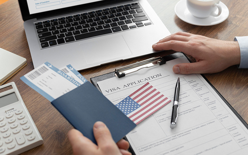 Visa application form with an American flag in the background.