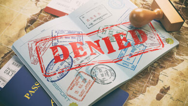Passport with a denied US visa stamp, symbolizing US visa rejection rates.