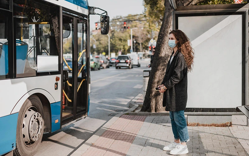 Woman waiting at a bus stop in New York City.