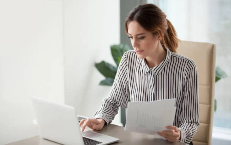 women checking visa status on laptop