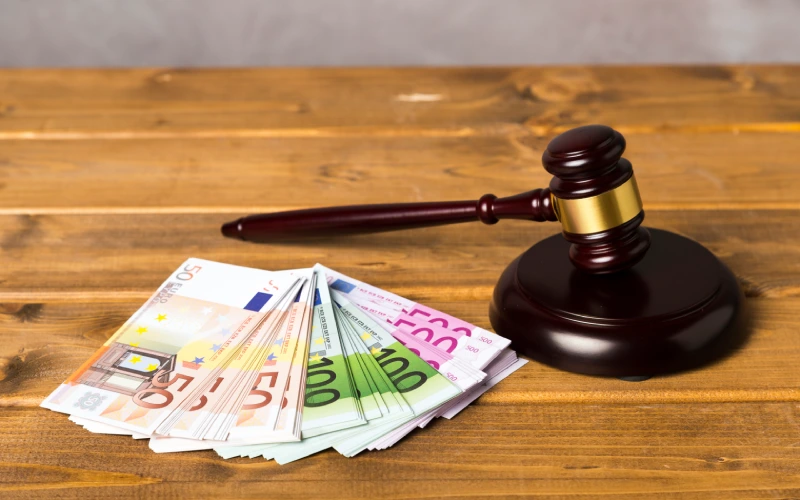 Judge’s gavel with euro banknotes on wooden table