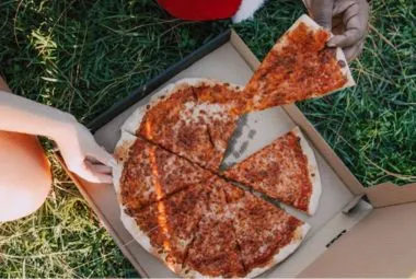 Open Paper Box of Pizza on the Grass